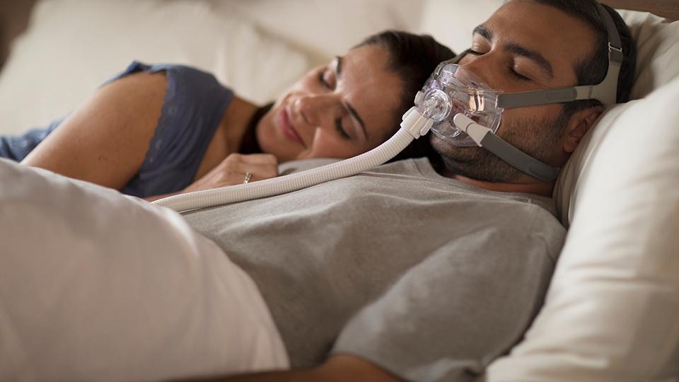 Couple sleeping with Amara mask