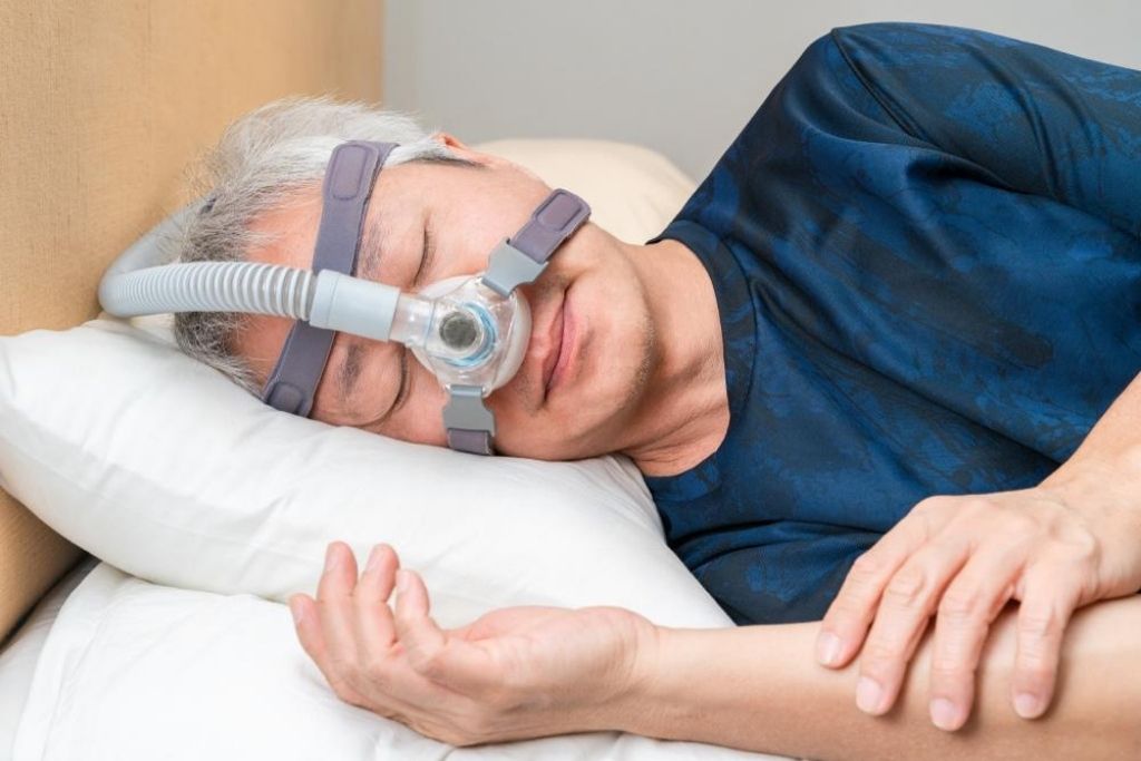 A man sleeping while wearing a CPAP mask