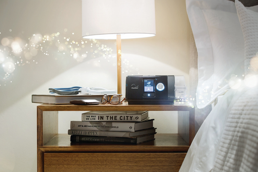 CPAP machine sitting on a nightstand