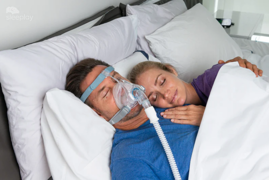 Person sleeping comfortably with a modern full face CPAP mask, showing relaxed sleep posture