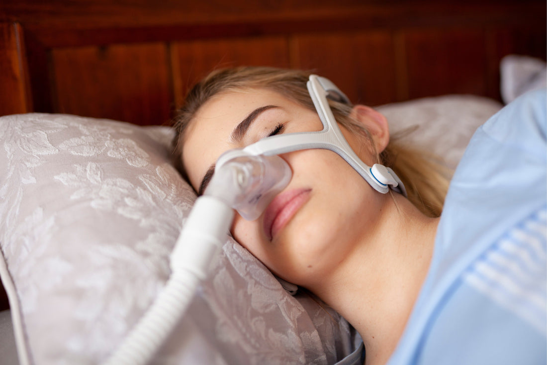 Woman sleeping on the side with CPAP Mask.