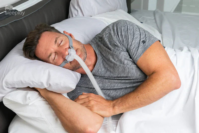 Man sleeping with CPAP mask