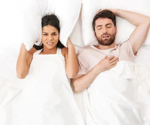 how to sleep with snoring partner