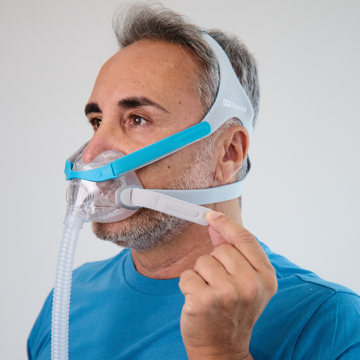 Man strapping his headgear.