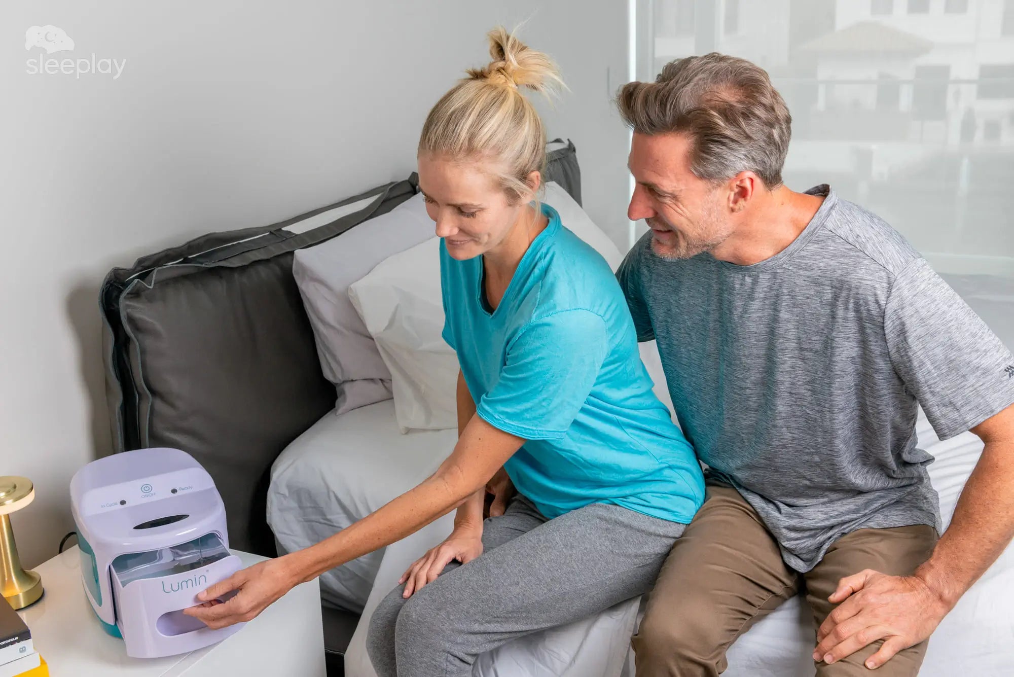 Woman opening Lumin CPAP cleaner next to mask.