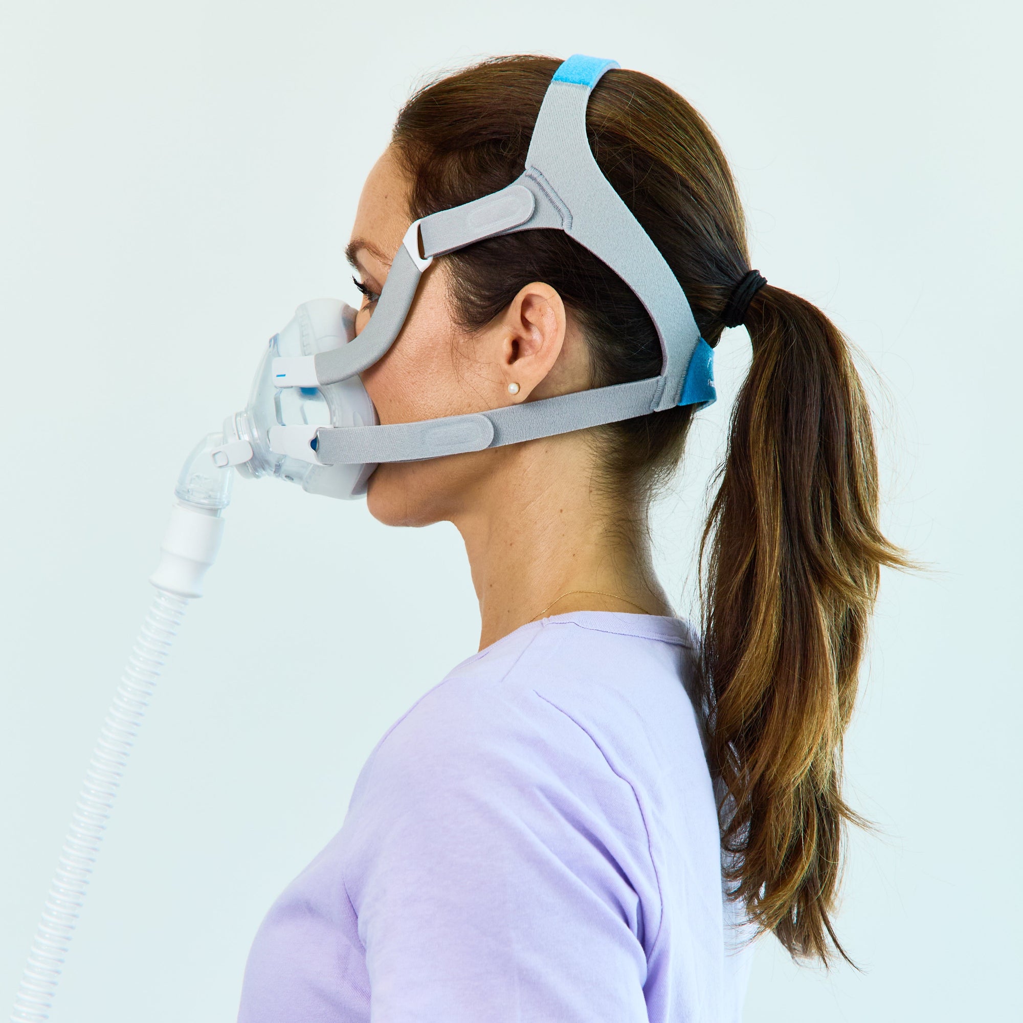 Woman wearing ResMed_AirFit_F20_Full_Face_Mask_with_Headgear - Side view