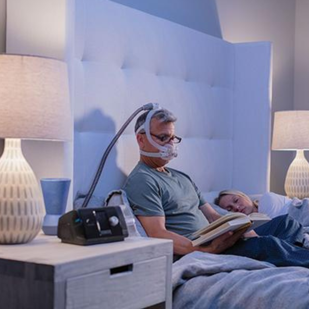 Man reading in bed with the F30i Standard System.