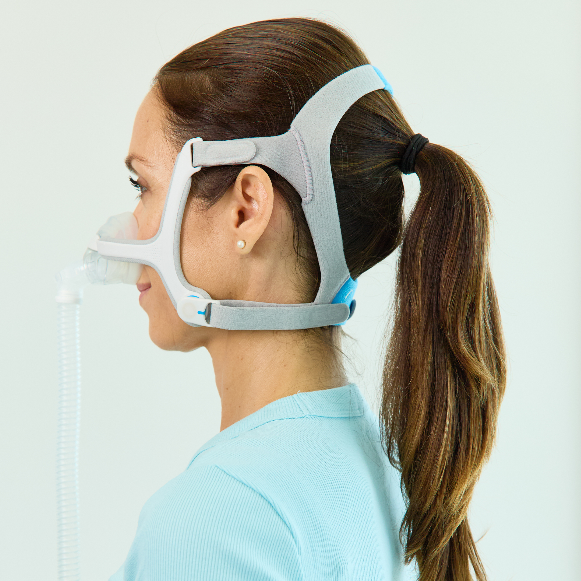 Side view of a woman using a ResMed AirFit™ N20 for Her Nasal CPAP Mask with Headgear