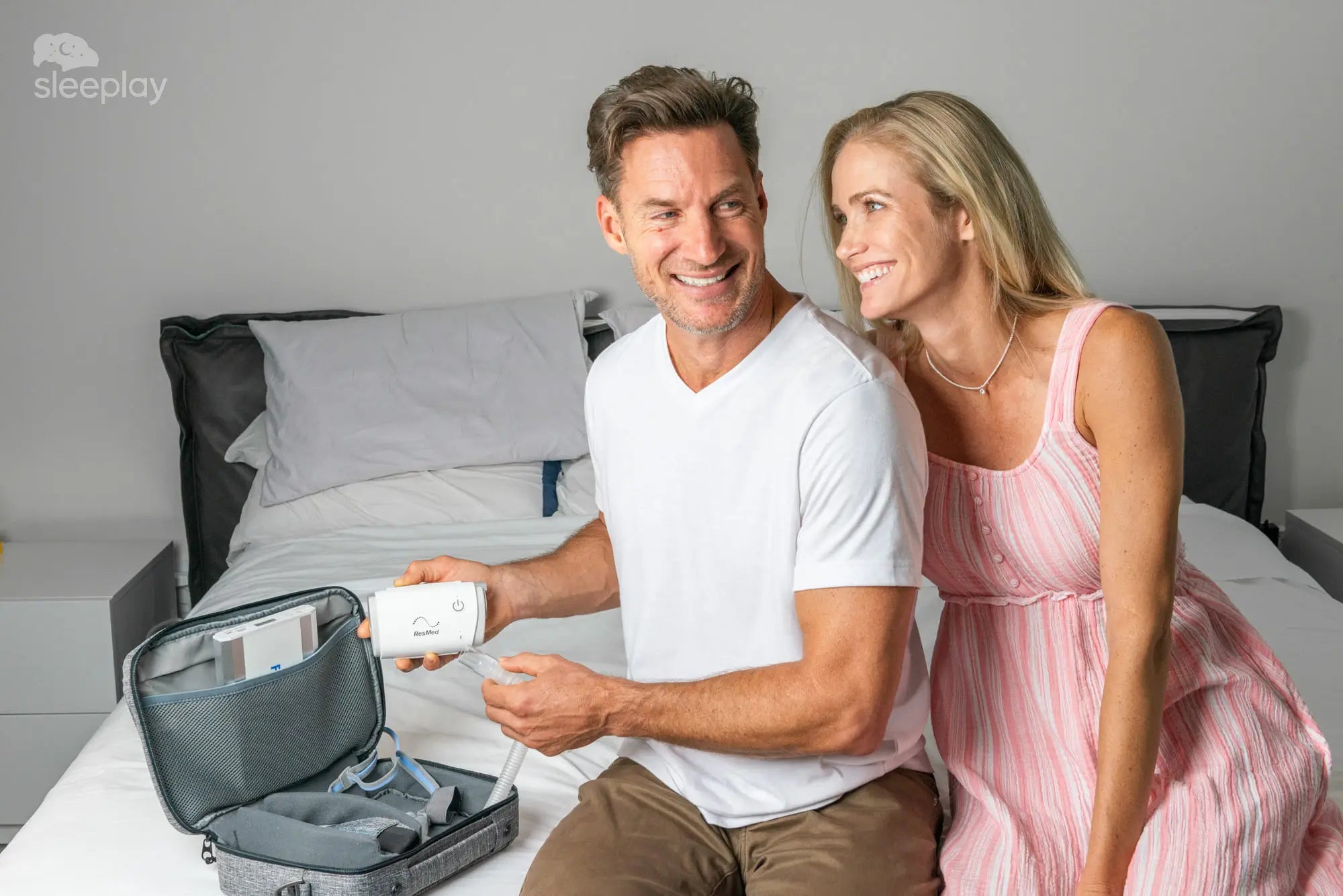 Couple showing AirMini travel CPAP.