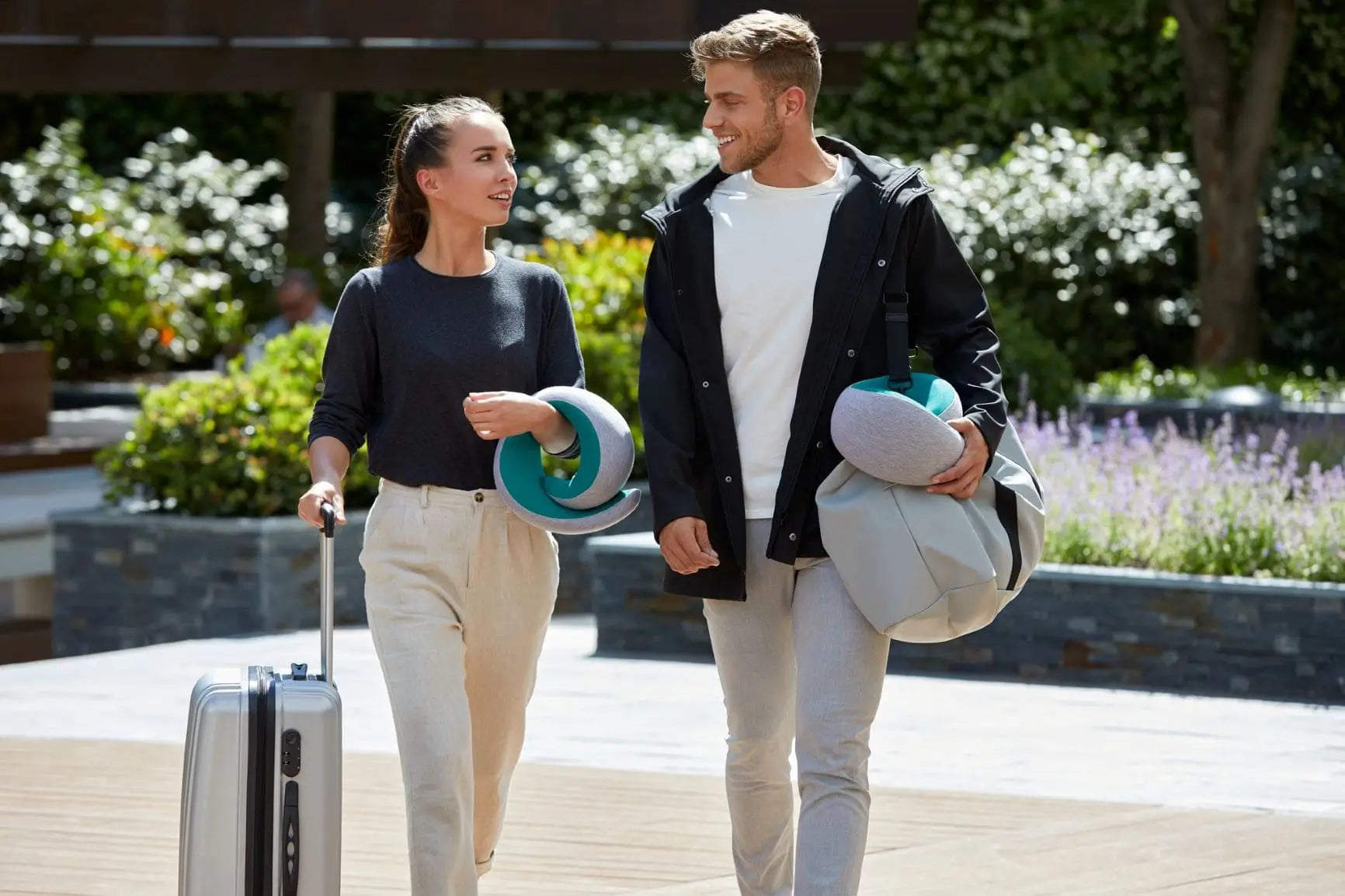 Couple Traveling With Neck Pillows.