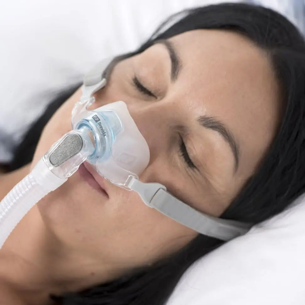 Woman sleeping with Brevida Nasal Pillow CPAP Mask