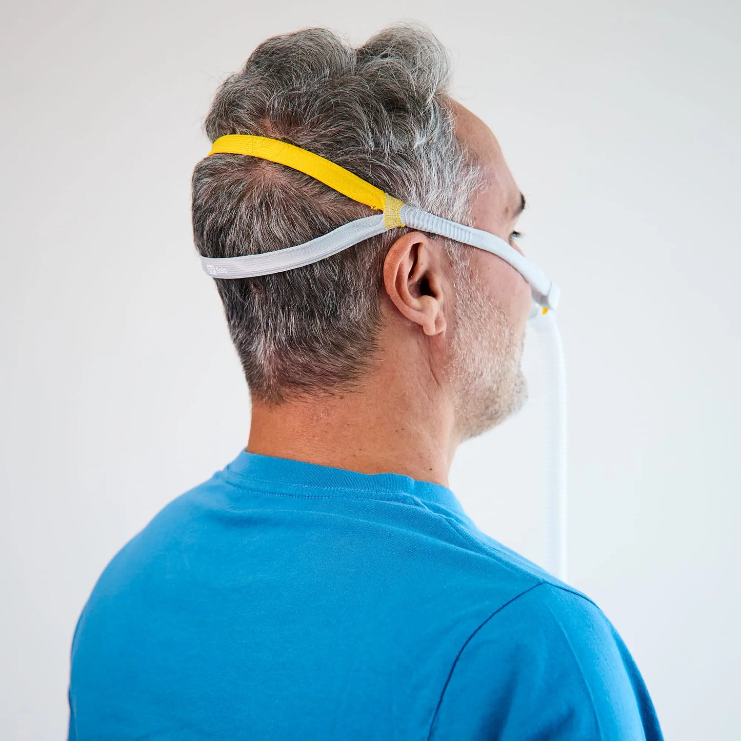 Back view of man using the solo nasal mask for cpap.