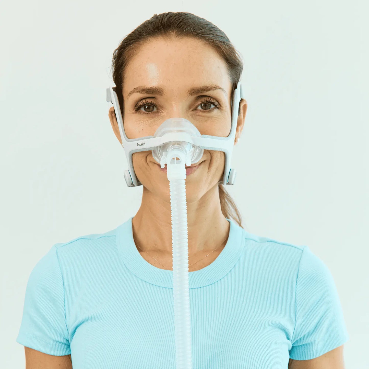 Front view of a woman using a ResMed AirFit™ N20 for Her Nasal CPAP Mask with Headgear