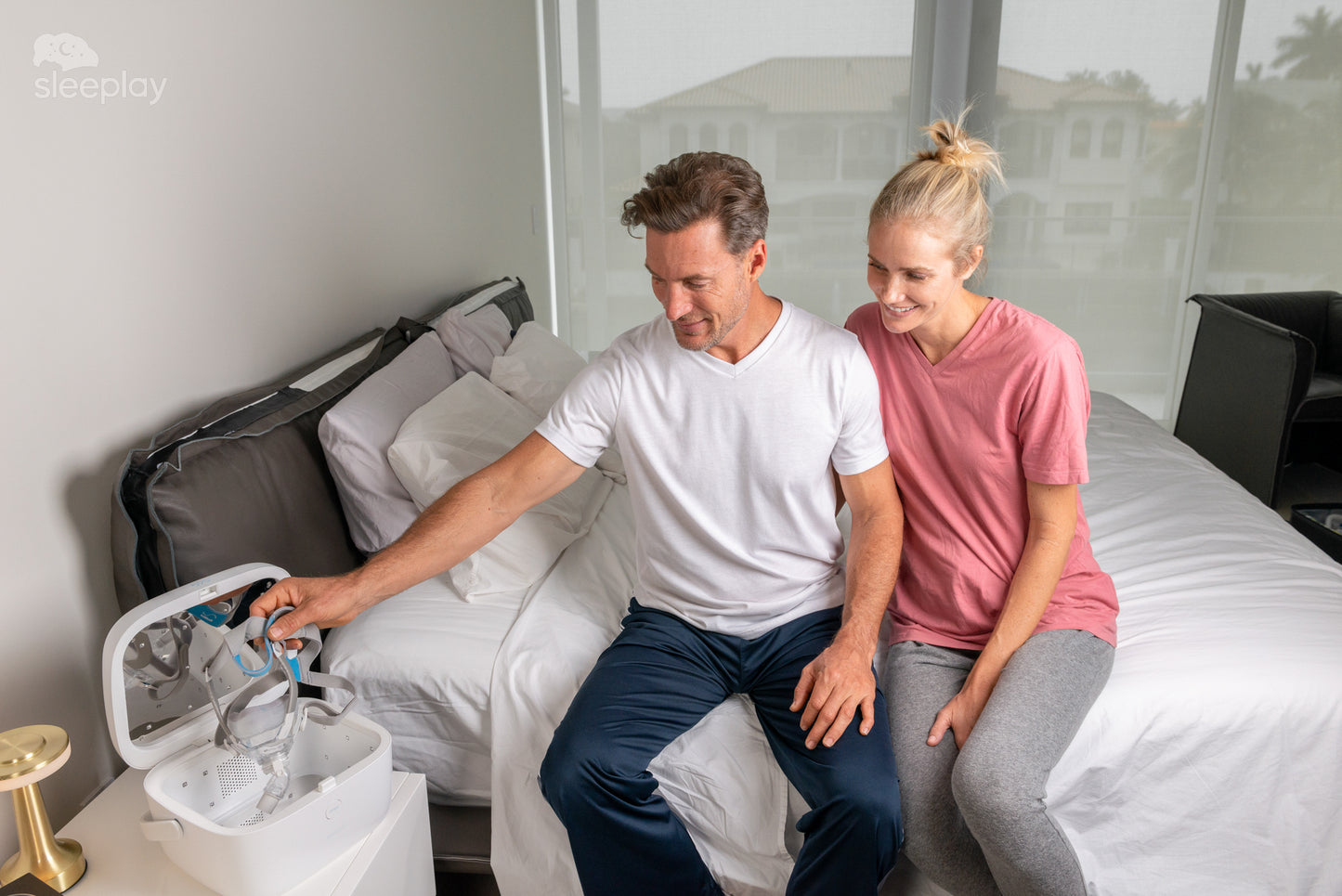Couple using the Paptizer CPAP cleaner.