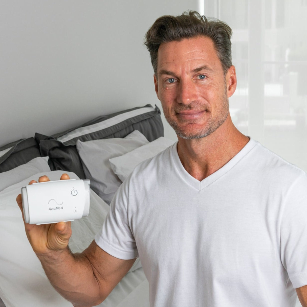 Man holding ResMed AirMini