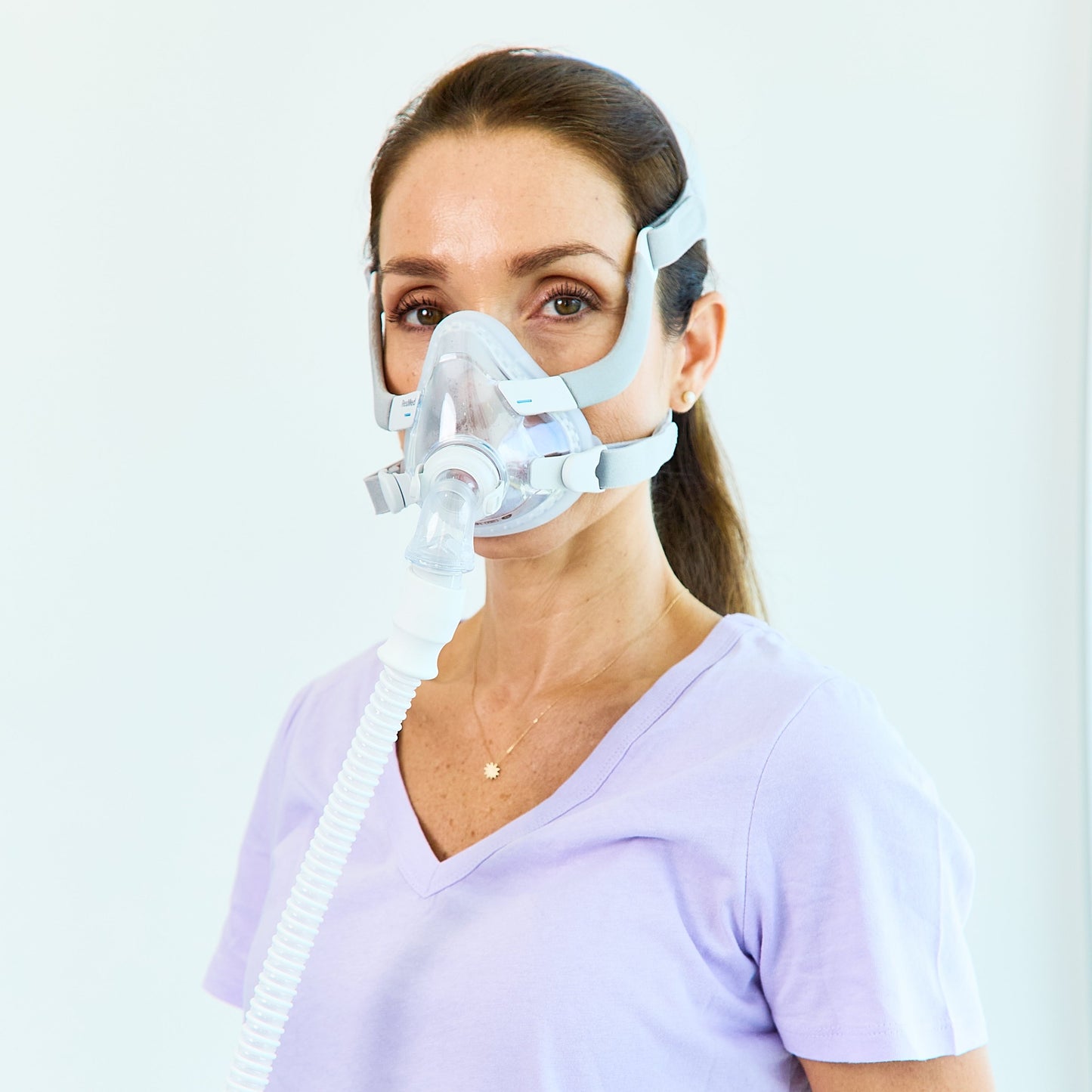 Woman wearing AirTouch F20 CPAP mask for her.