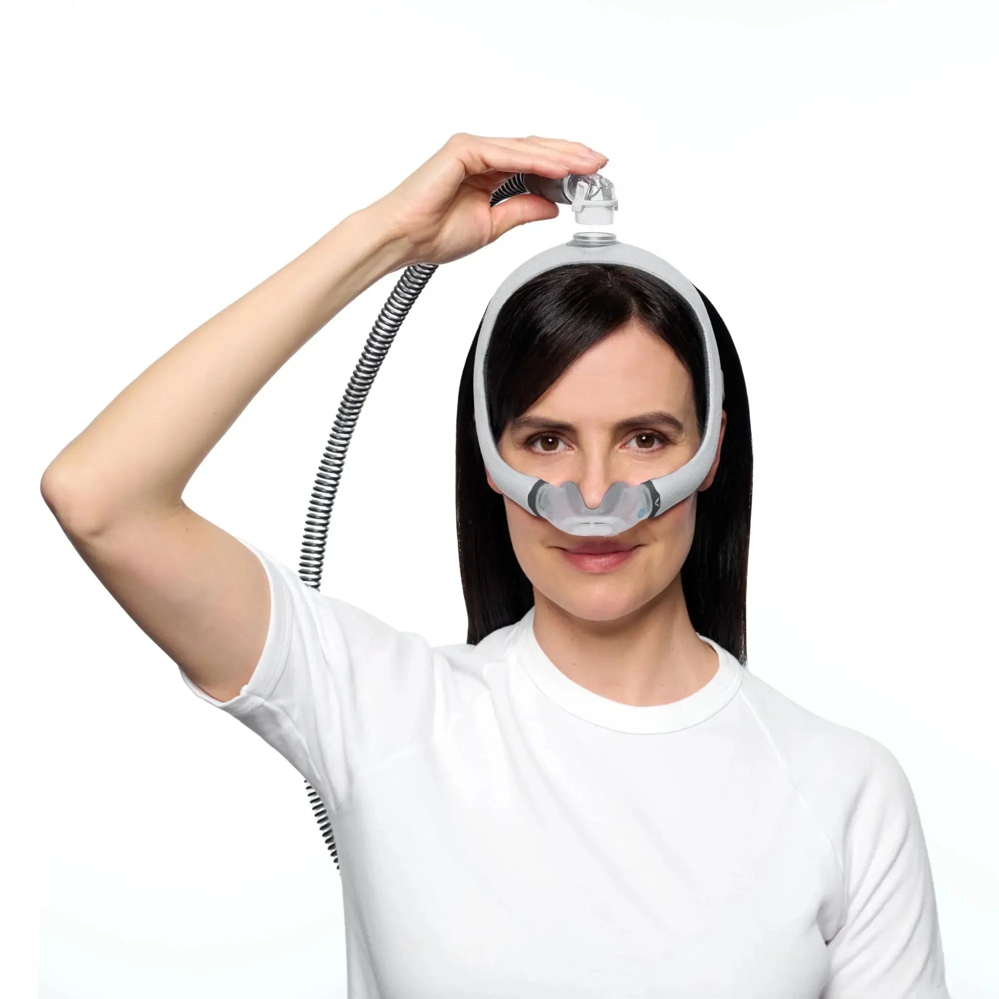 Woman fitting the ResMed AirTouch N30i Nasal CPAP Mask and top of the head tubing 