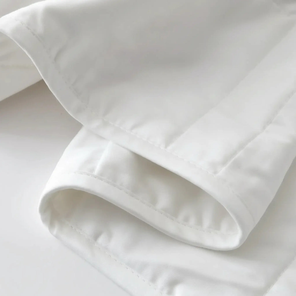 Close-up of the Baloo weighted comforter's smooth cotton shell and stitched edge seams