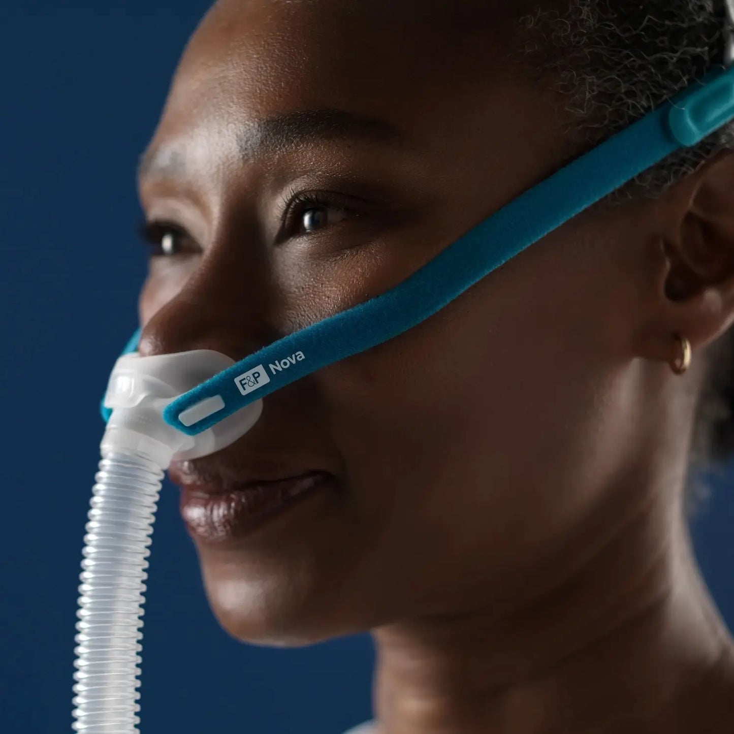 Close up to Woman using the F&P Nova Micro™ Nasal Pillows CPAP Mask