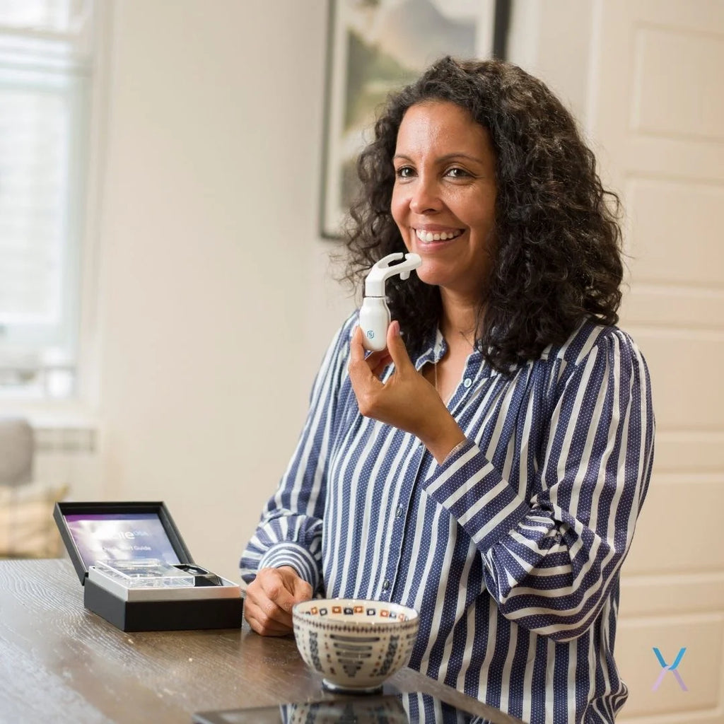 Woman using the eXciteOSA daytime therapy device at home during a 20 minute session