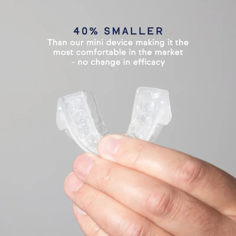 Hand holding the clear, compact Hushd Avera anti-snoring mouthpiece trays