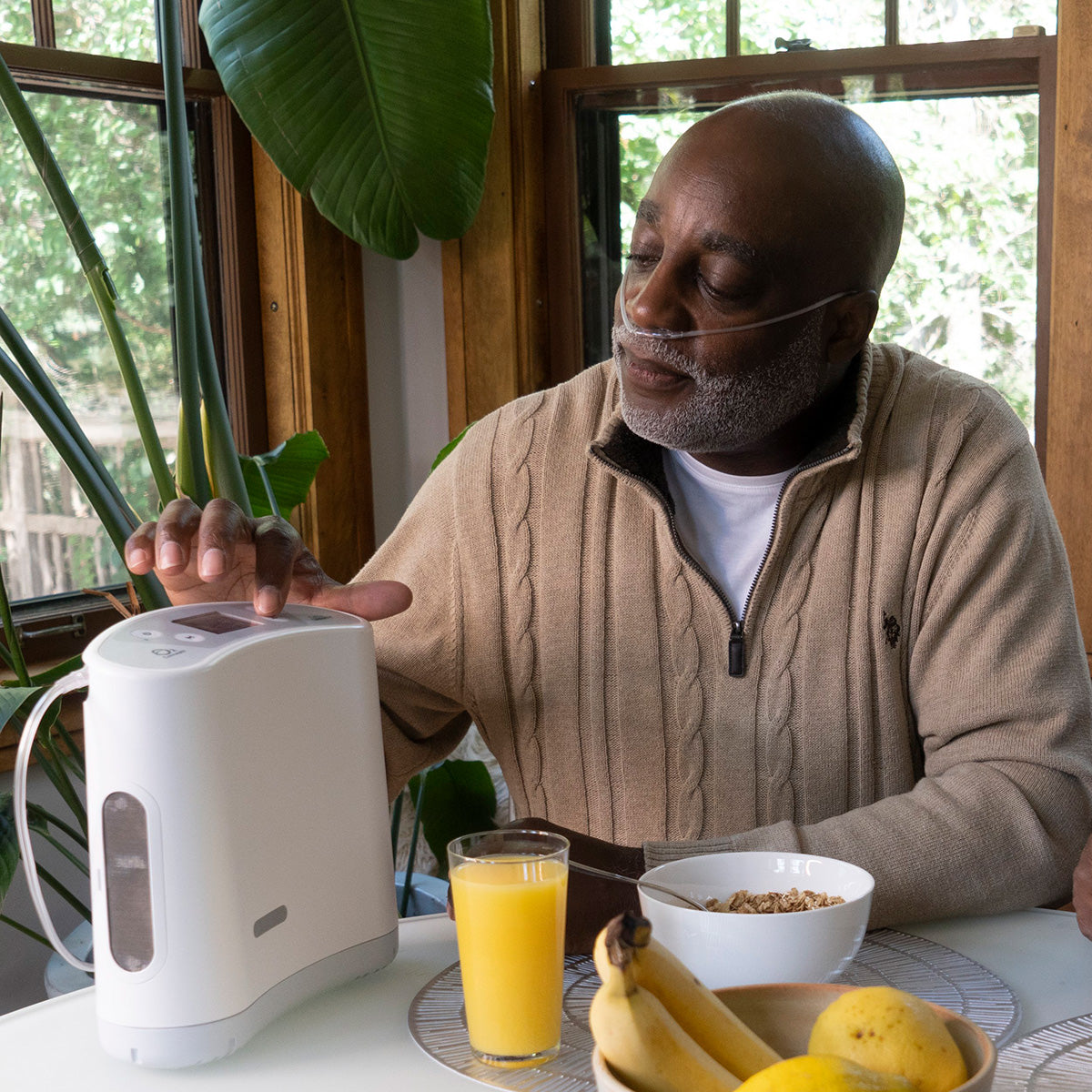 Man using OxLife Liberty 2 Portable Oxygen Concentrator Bundle