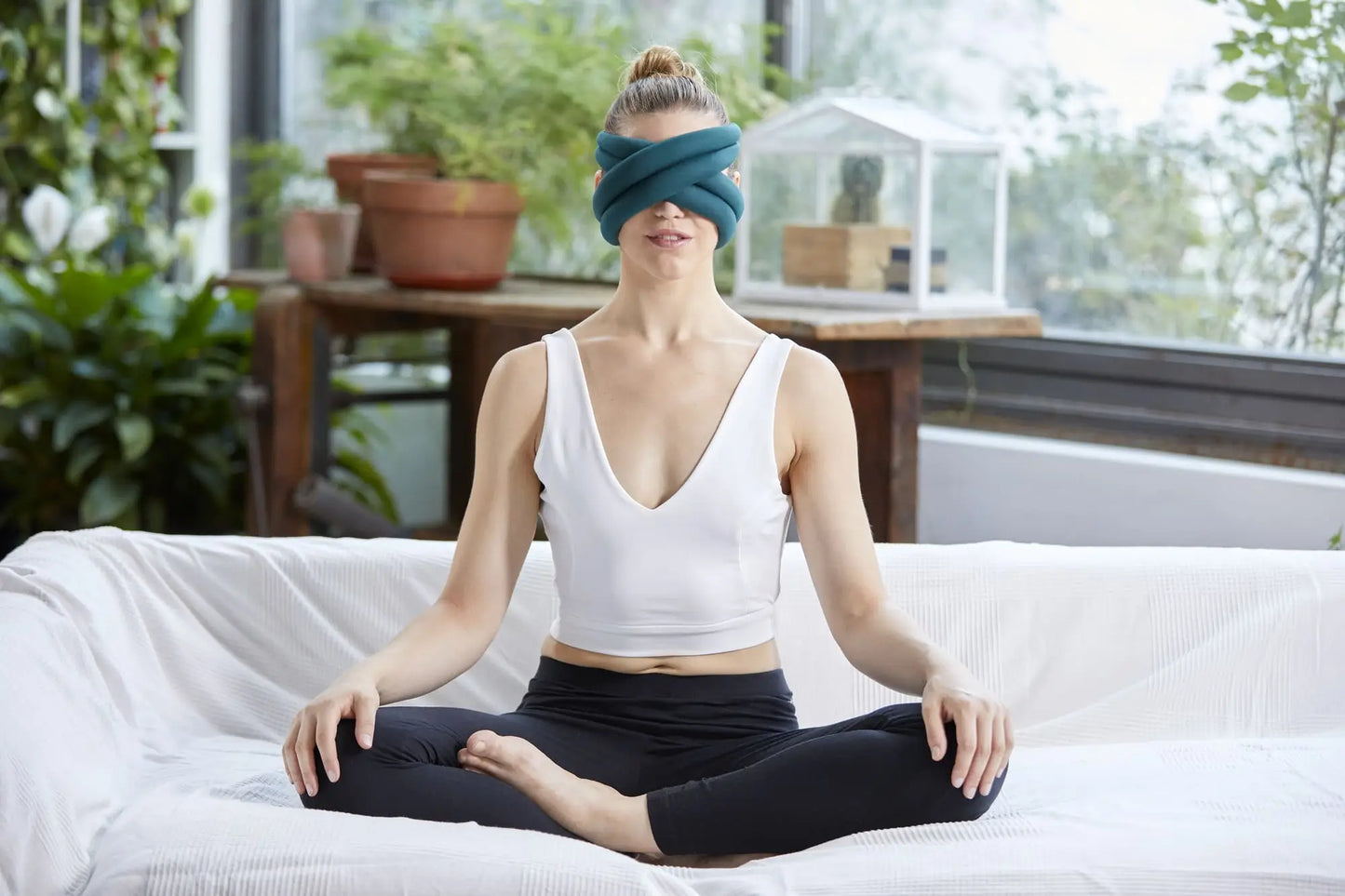 Woman doing yoga with the Loop Eye Pillow