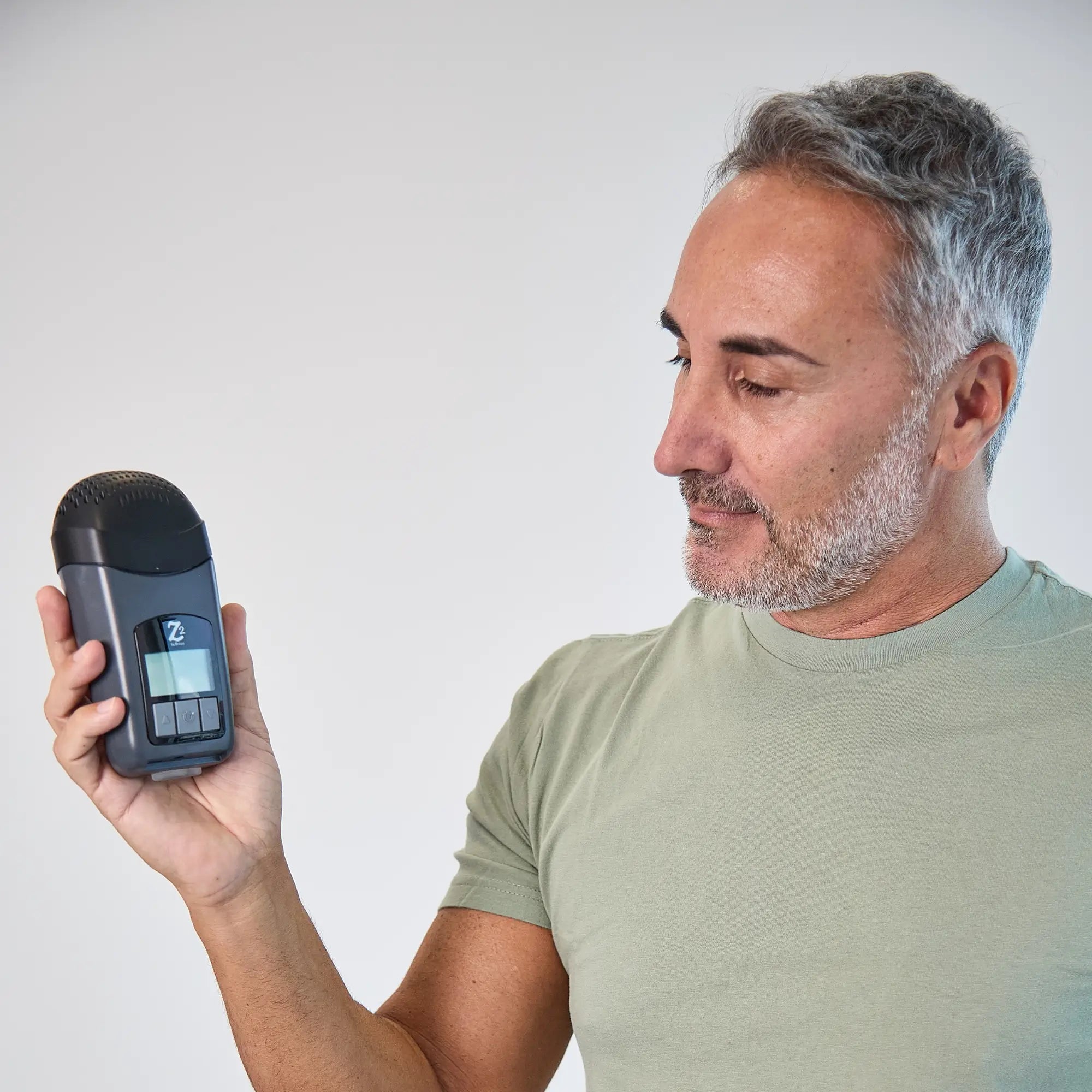 man holding the Z2 Auto Travel CPAP Machine