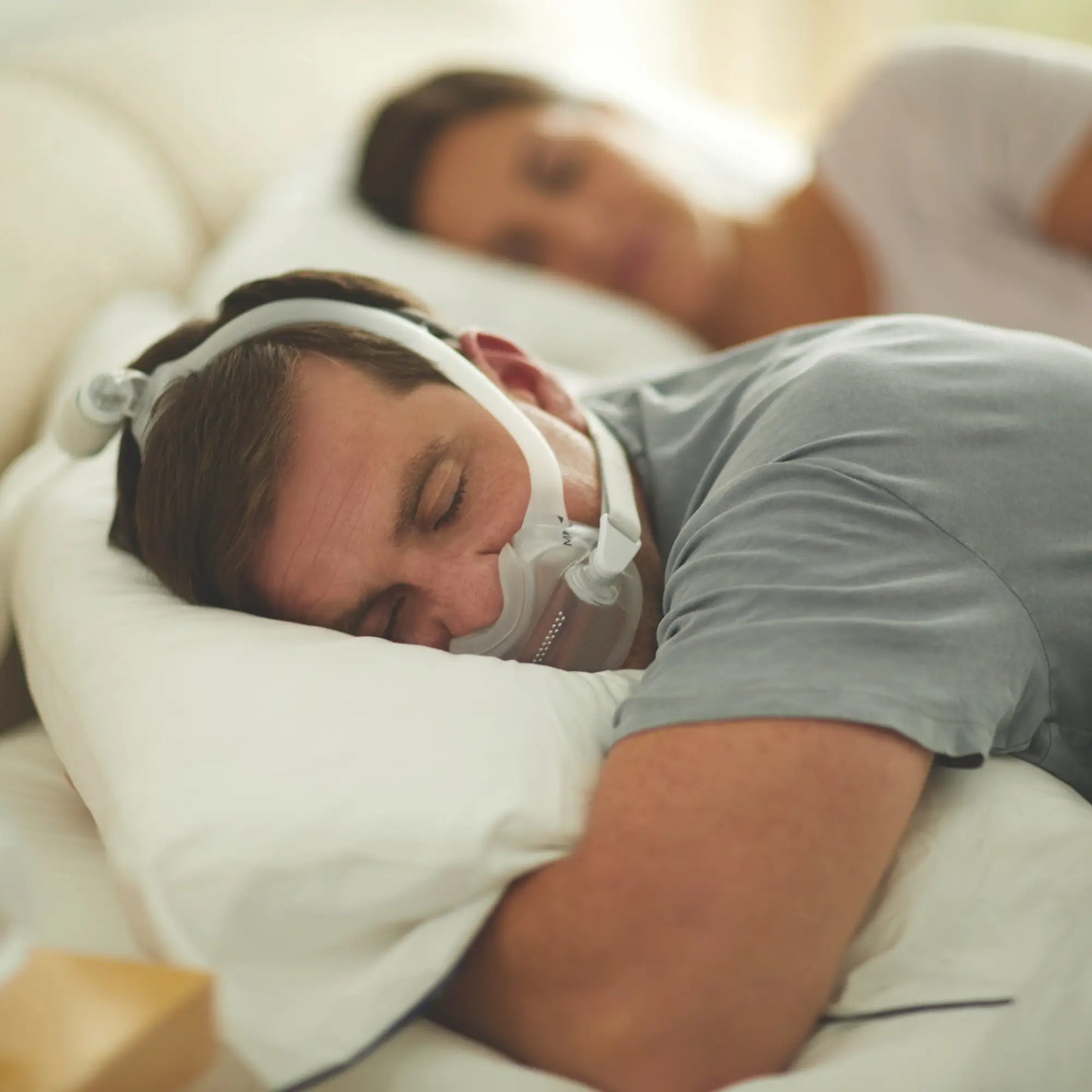 man sleeping in his back and using the DreamWear Full Face CPAP Mask with Headgear.