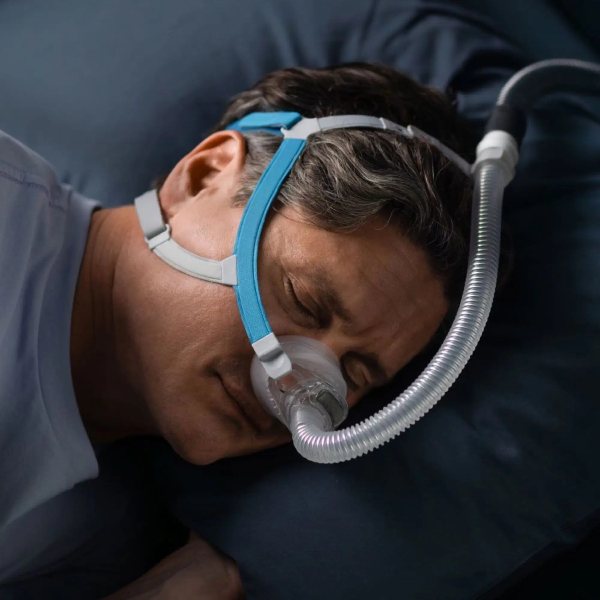 man sleeping with the F&P Nova Nasal CPAP & BiPAP Mask