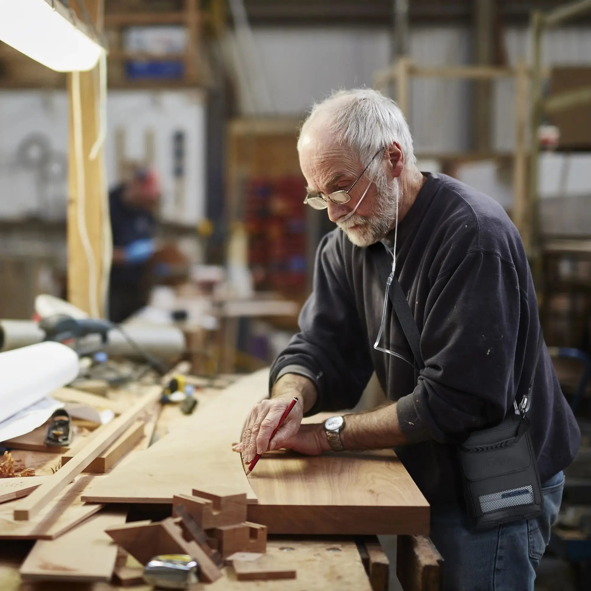 man working  and using the Inogen Rove 6 Portable Oxygen Concentrator