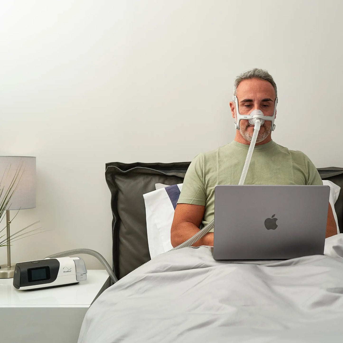 man using the ResMed AirFit N20 Nasal CPAP Mask with Headgear while using the pc