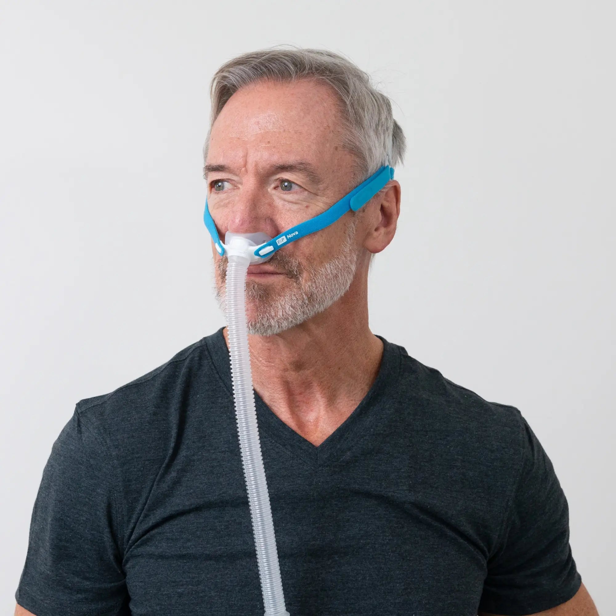 man using the F&P Nova Micro Nasal Pillows CPAP Mask side view  sleeplay copyright 