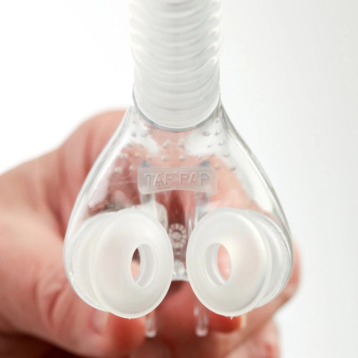 Macro close-up of myTAP PAP soft silicone nasal pillows from below with TAP PAP embossed branding visible