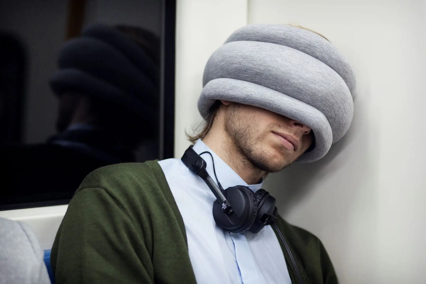 man using the Light Versatile Travel Pillow in the train