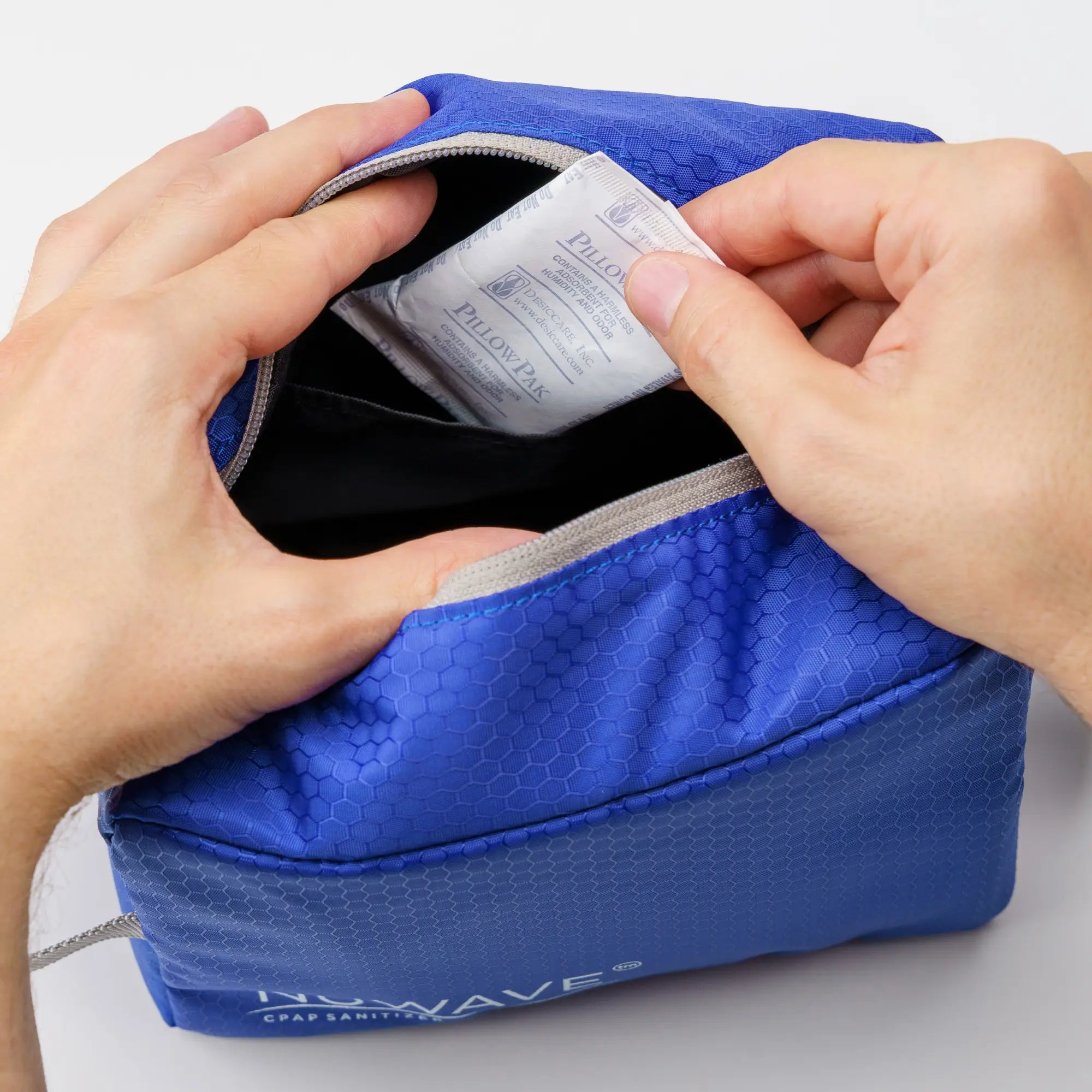 Hand inserting the replacement filter into the Nuwave Portable Sanitizer Cleaner Machine