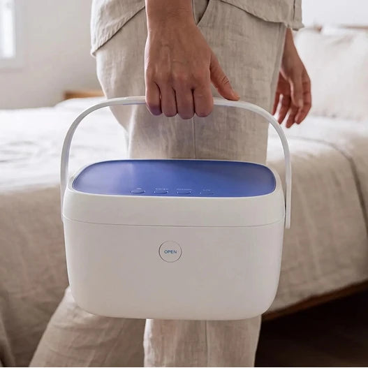 Carrying the Paptizer 360 CPAP sanitizer by its built-in top handle