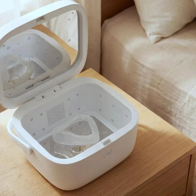 Paptizer 360 CPAP sanitizer open on a nightstand with a mask cushion on the tray
