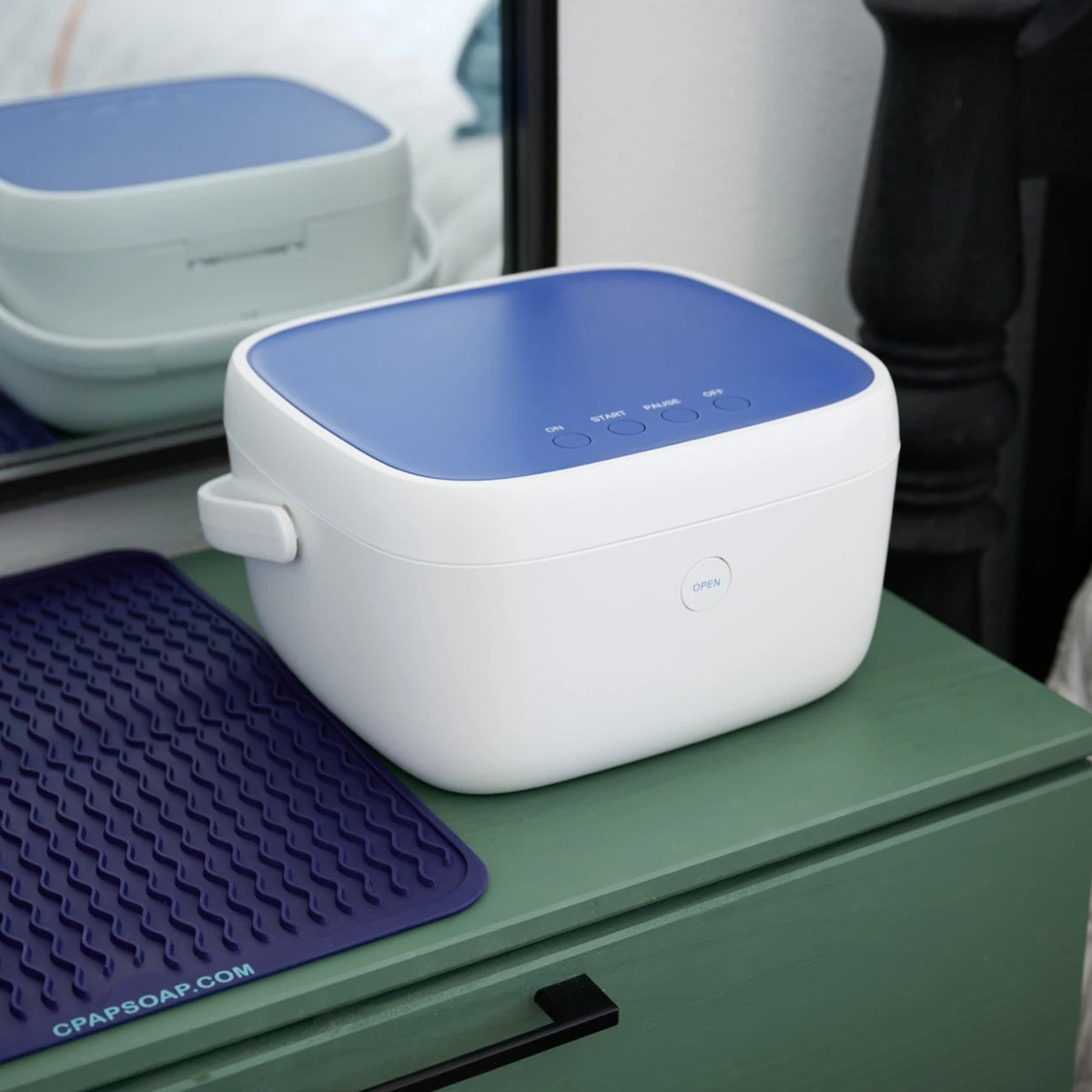 Compact Paptizer 360 CPAP sanitizer on a nightstand, sized for travel