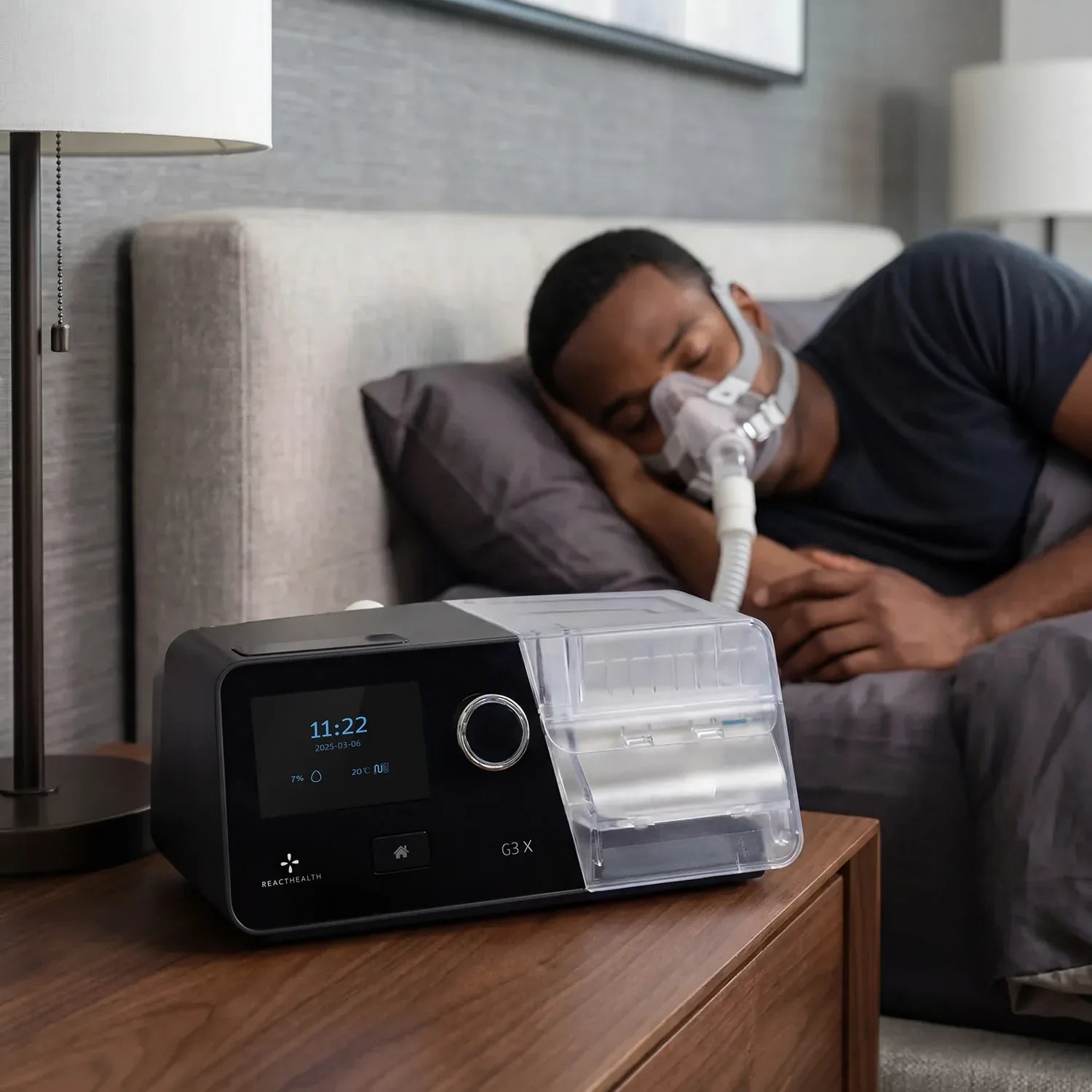 Man asleep while using the React Health G3 X Auto-CPAP machine for sleep apnea therapy