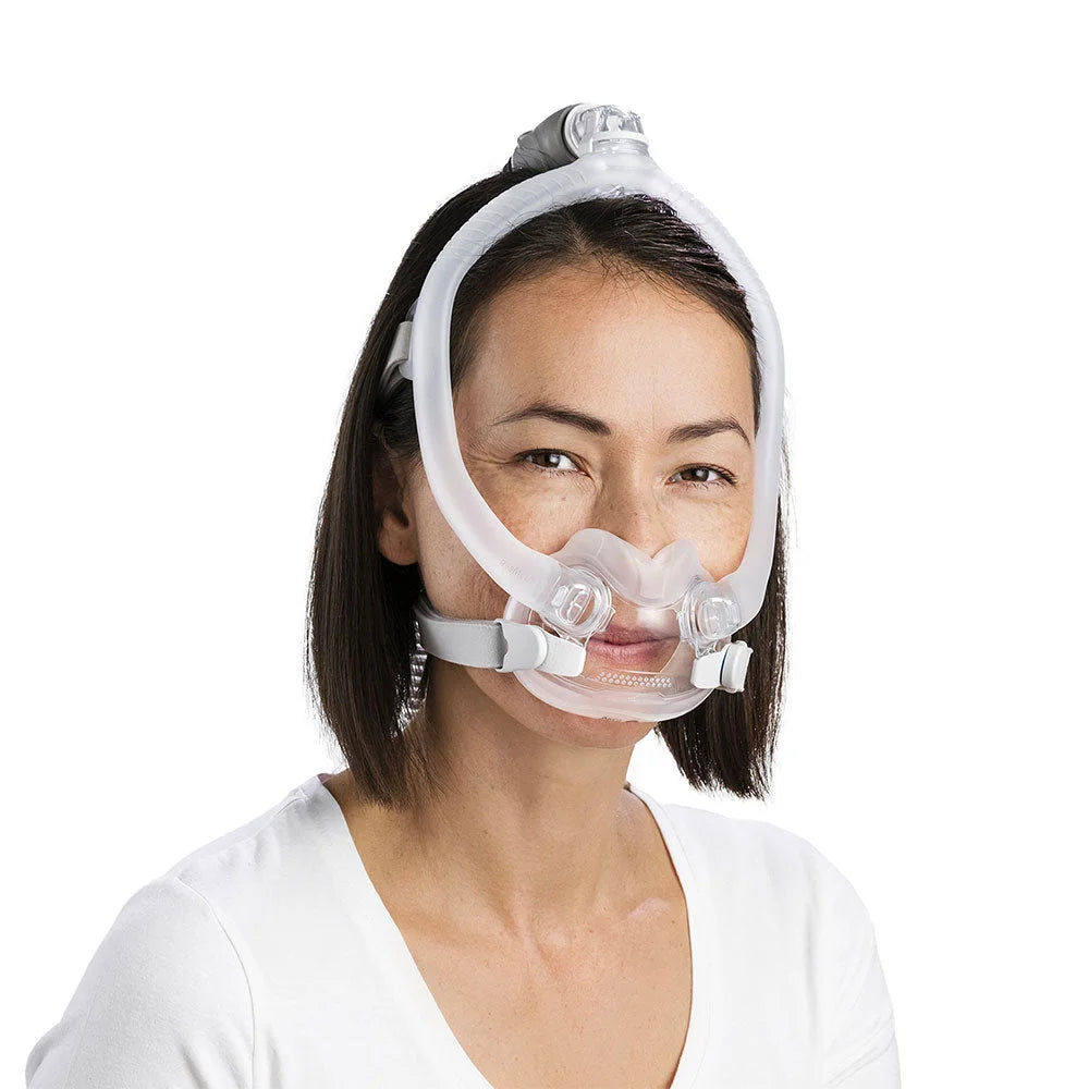 Woman wearing the ResMed AirFit F30i full face mask with top-of-head tube connection