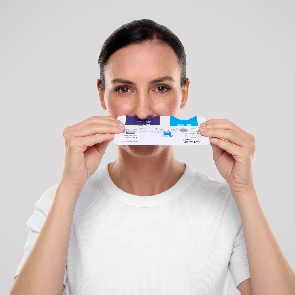 Woman holding the ResMed AirTouch F40 sizing guide under her nose to choose a cushion size