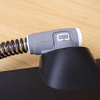 ClimateLineAir heated tube connector locked into the air outlet of a black CPAP machine, top view