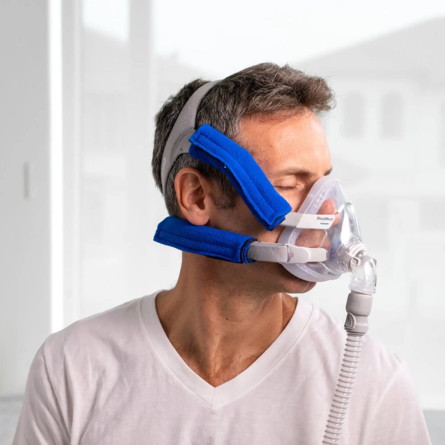 man using the Snugell CPAP Strap Covers for CPAP and BiPAP Masks (4-PACK)