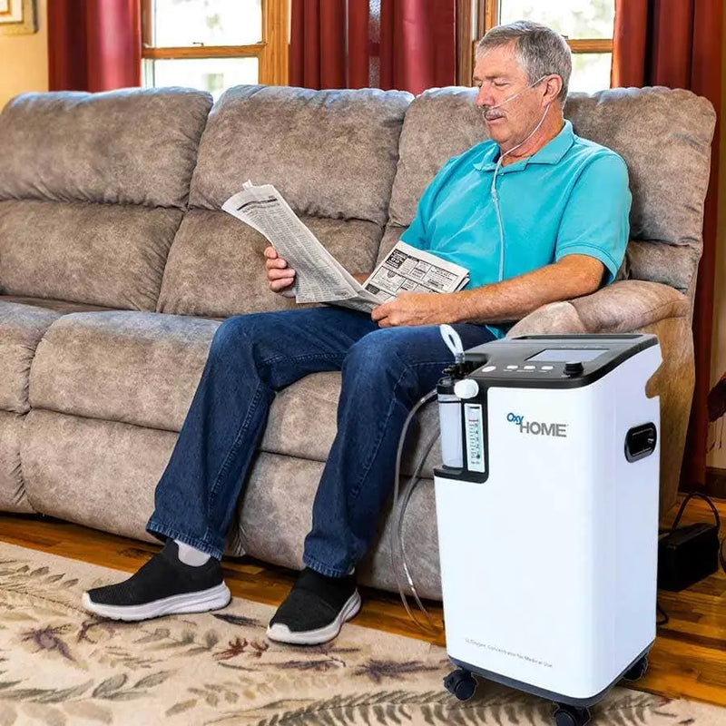 man using the OxyHome Stationary Oxygen Concentrator while reading