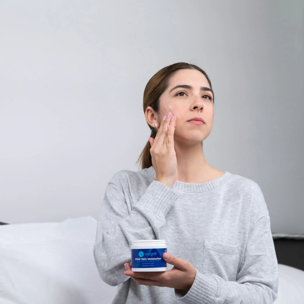 Woman applying the Snugell CPAP Skin Moisturizer Daily Face Cream