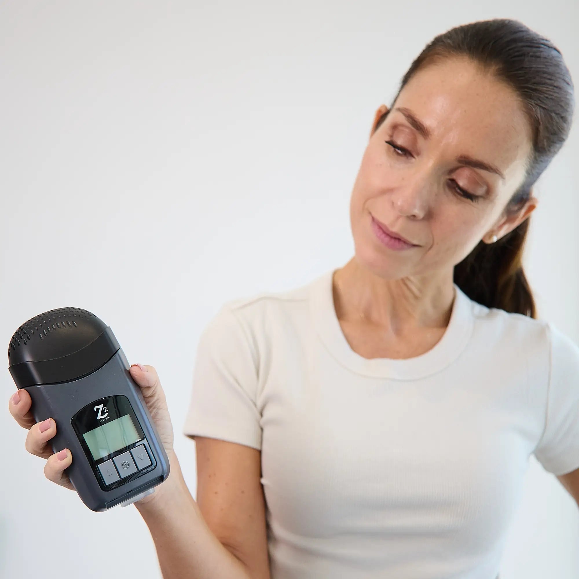woman holding the Z2 Auto Travel CPAP Machine