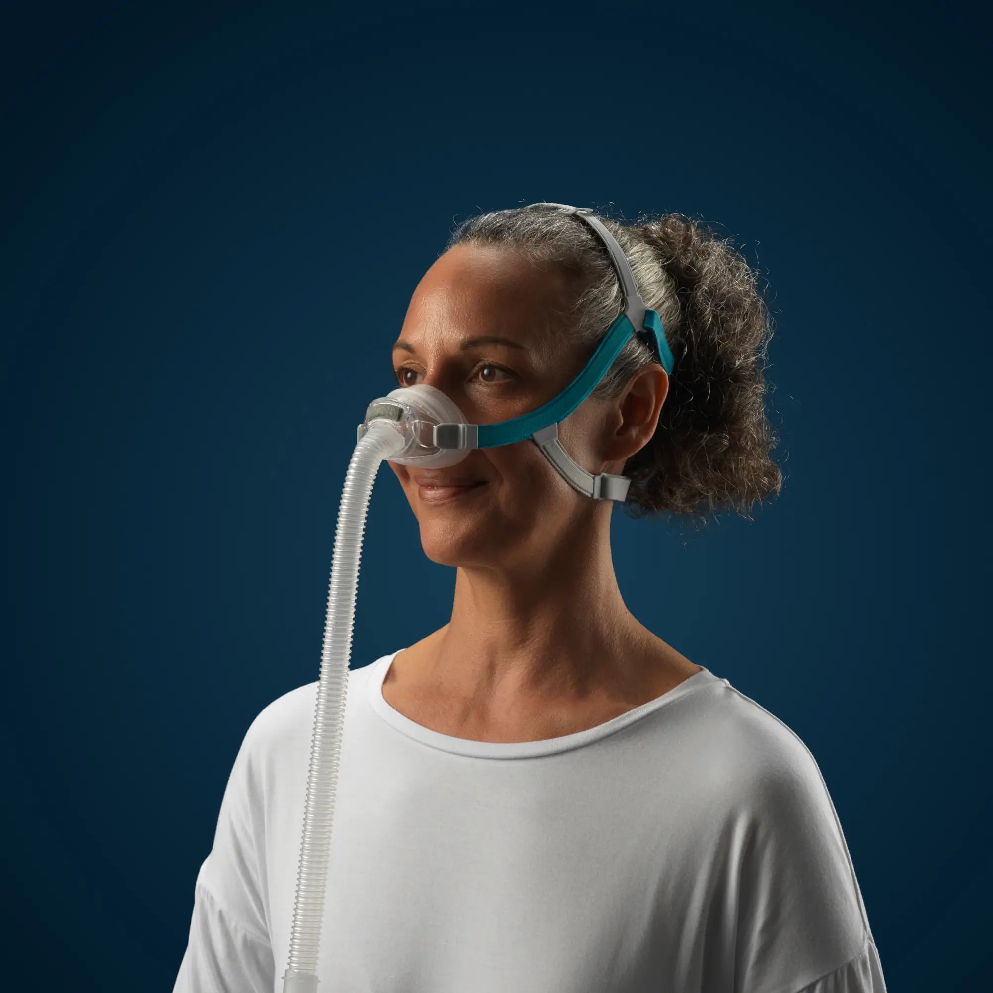 woman using the F&P Nova Nasal CPAP & BiPAP Mask side view