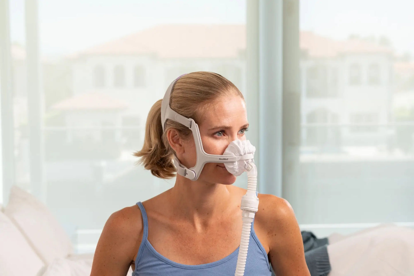 Woman using the nasal cpap mask liner