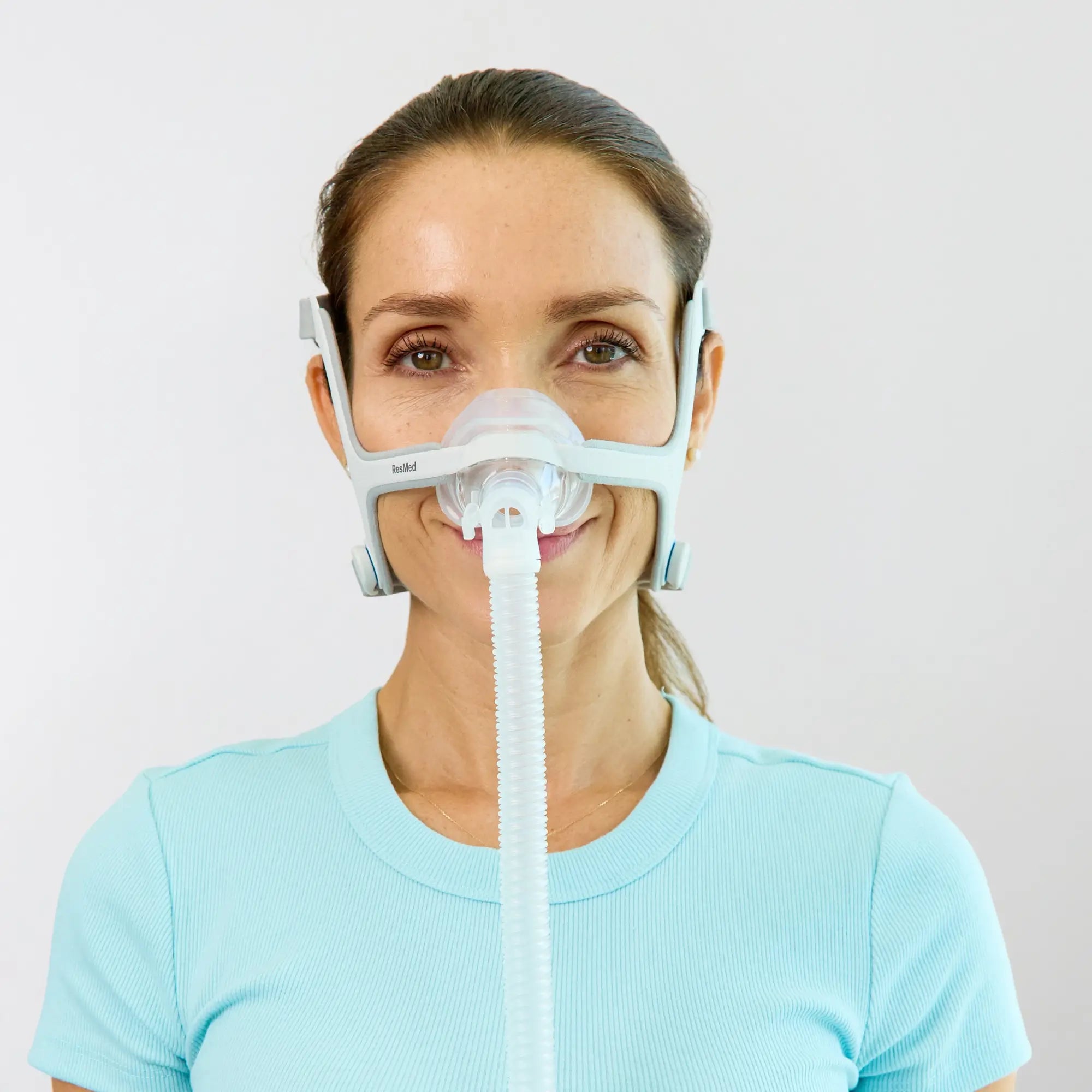 woman using the ResMed AirFit N20 Nasal CPAP Mask with Headgear front view